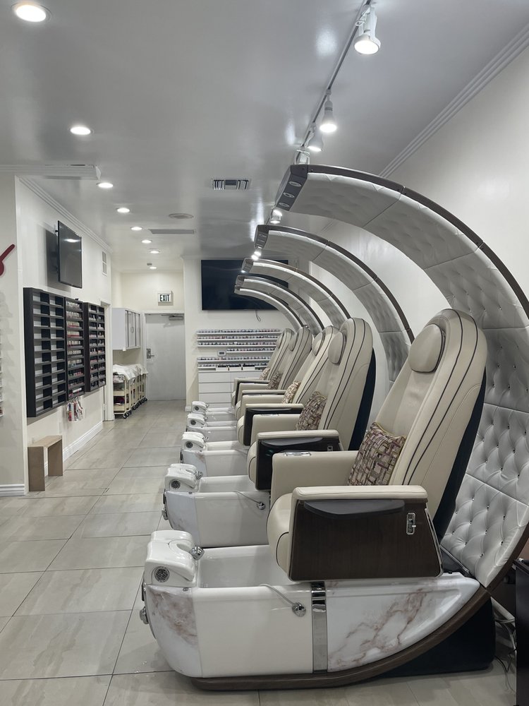 Inside X Nails in Sherman Oaks: a bright salon with cream tufted pedicure chairs, marble basins and espresso wood